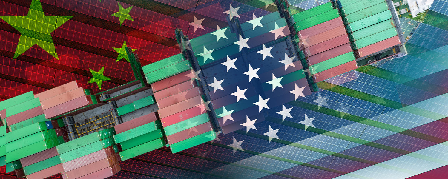 A cargo ship full of cargo containers is heading along the bottom left to upper right diagonal. There is a Chinese flag to the left, and a United States flag to the right. From the upper left to bottom right diagonal, there are rows of solar panels.