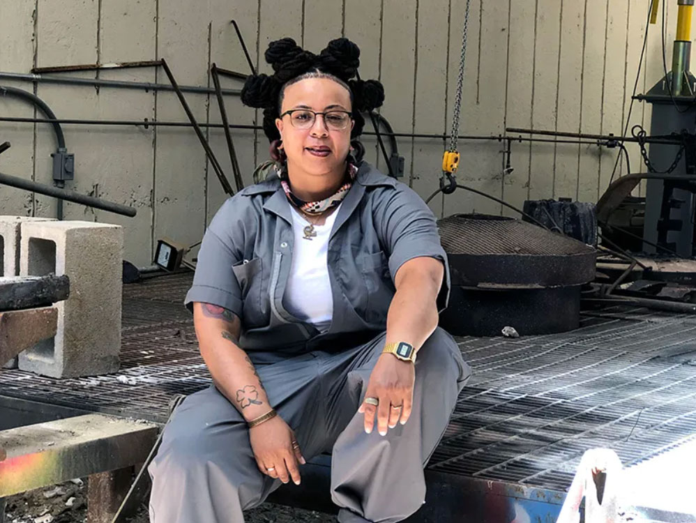 Art alum and former faculty member Jer'Lisa Devezin poses in a studio.