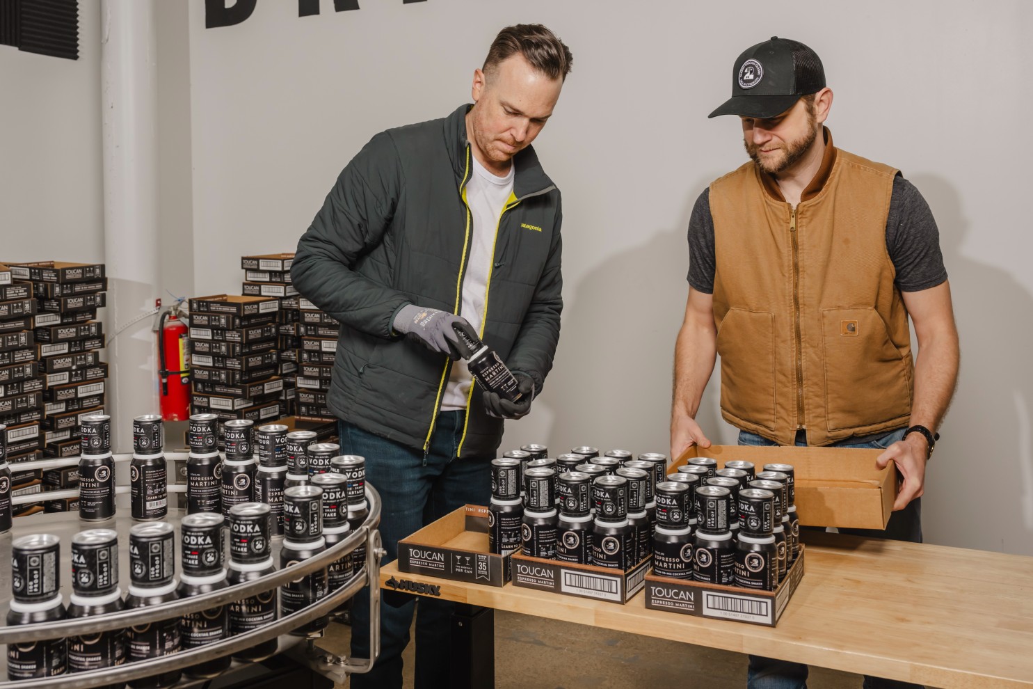 John Dallager and Steve McCarthy put together cans of Toucan Cocktails