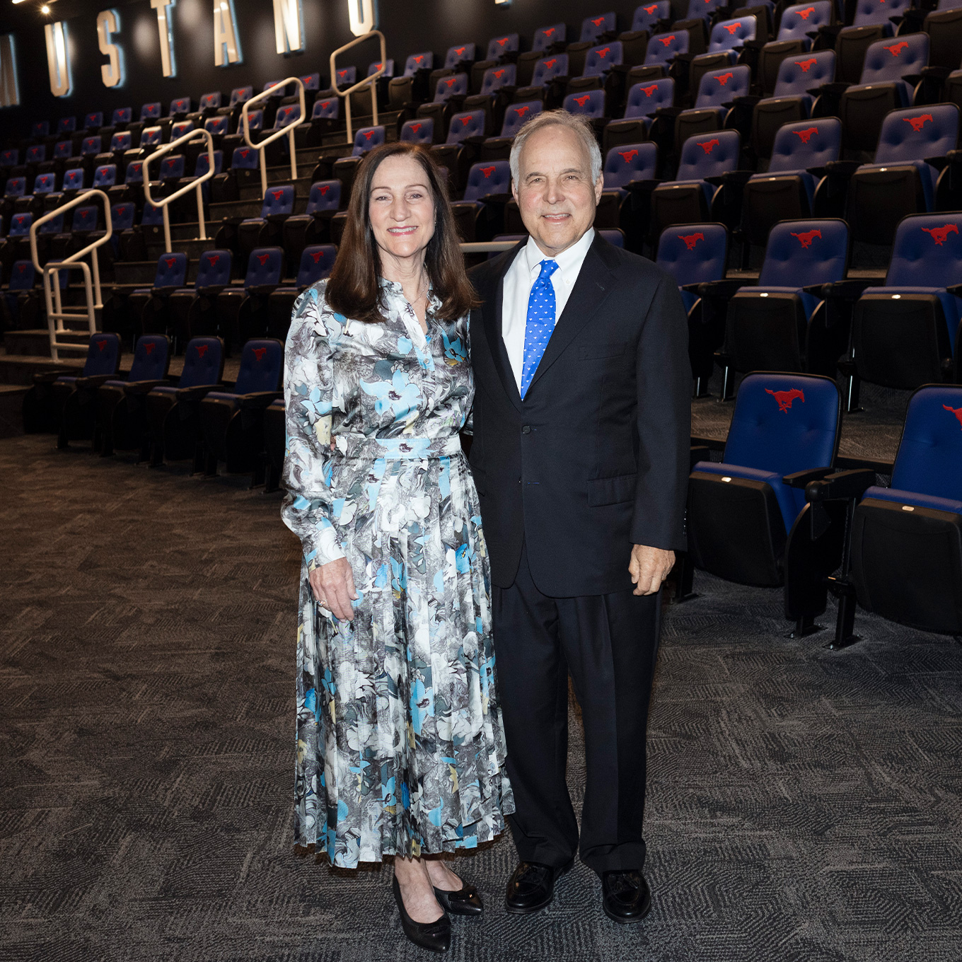 Kim M. and William C. Shaddock ’74 in the Shaddock Family Auditorium inside the Garry Weber End Zone Complex.