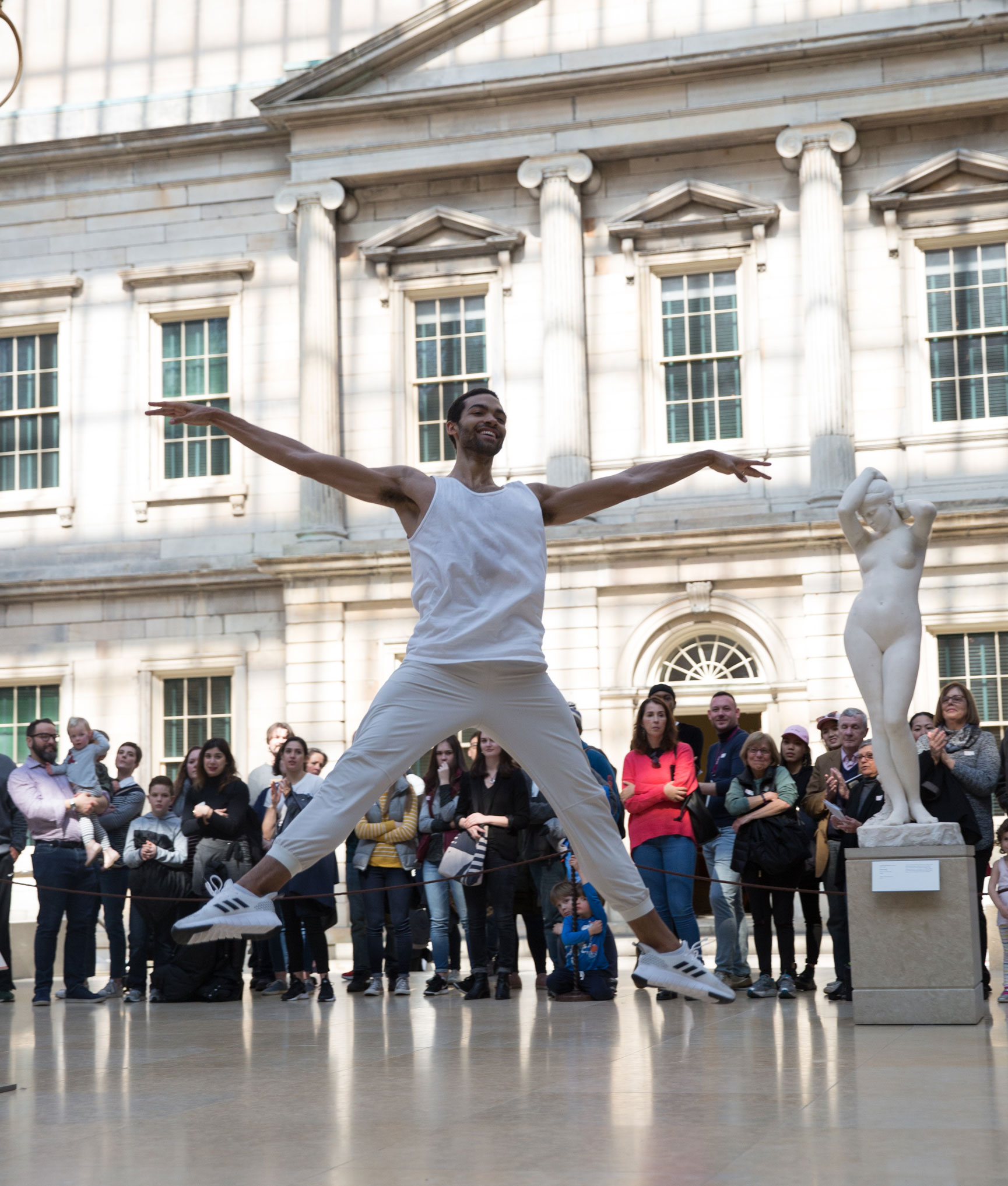 Dance professor Silas Farley performs in a public square.