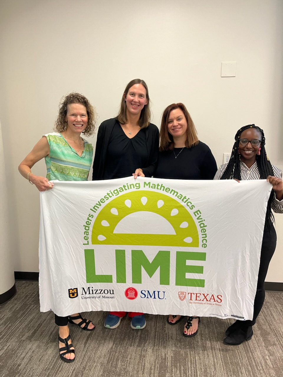 LIME project faculty and participants hold a flag with the LIME logo.